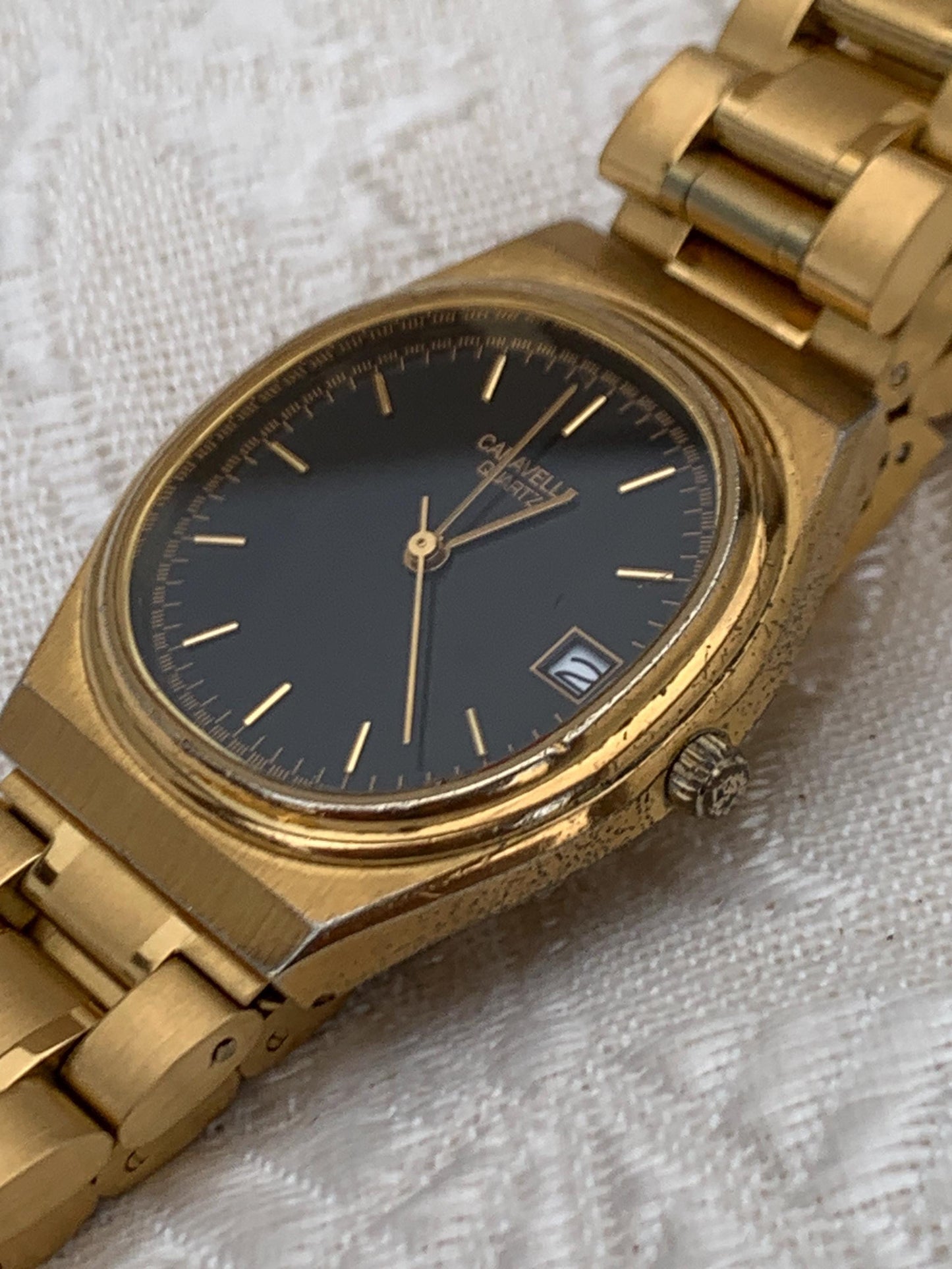 Worn 1992 Caravelle Cushion Quartz Watch by Bolova Gold Tone Finish, Black Dial with Date, New battery. New Bracelet. Presentable.