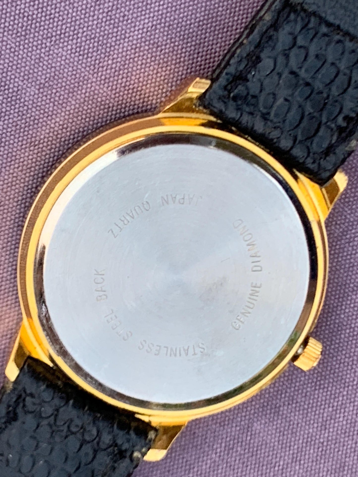 Manhattan 'Diamond' Quartz Museum watch. Fancy lugs, great gold tone. Black dial without indices. Keeps time well. 1990s. Small chip crystal