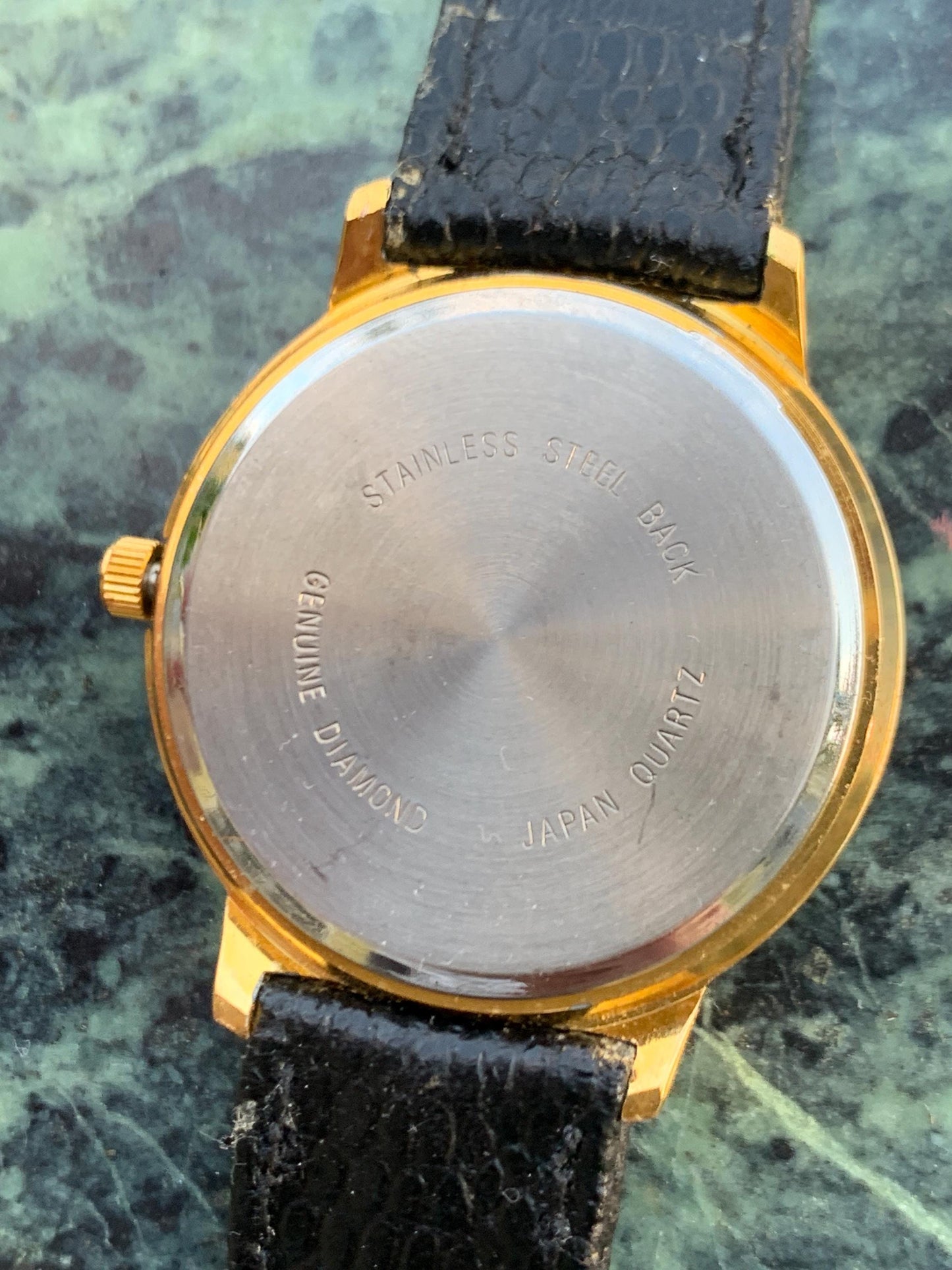 Manhattan 'Diamond' Quartz Museum watch. Fancy lugs, great gold tone. Black dial without indices. Keeps time well. 1990s. Small chip crystal