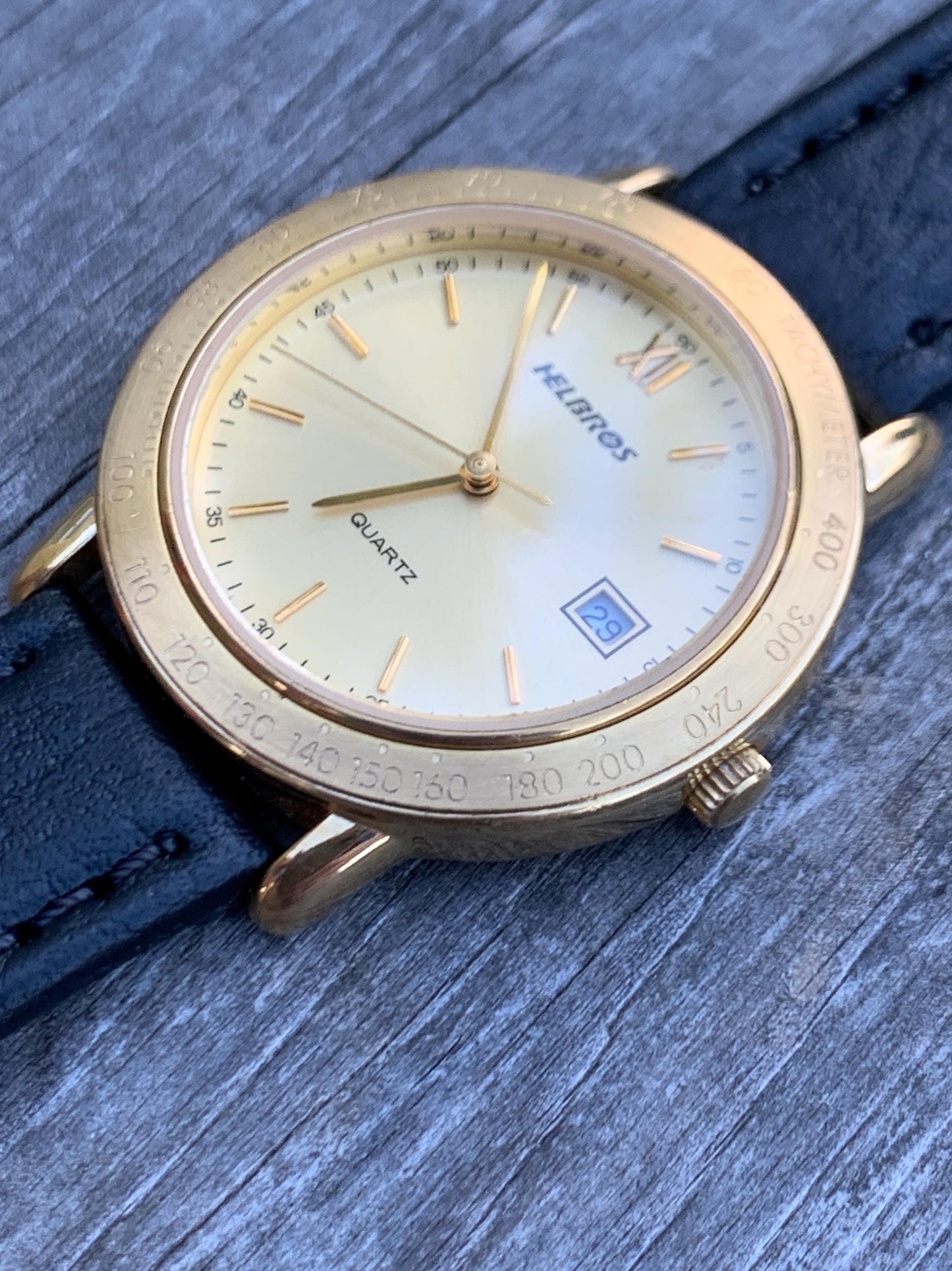 Millennial Era Helbros Quartz Watch Gold Tone Finish, Tachymeter Bezel, Gold Dial with Date New battery. New Black Calf Leather Band.