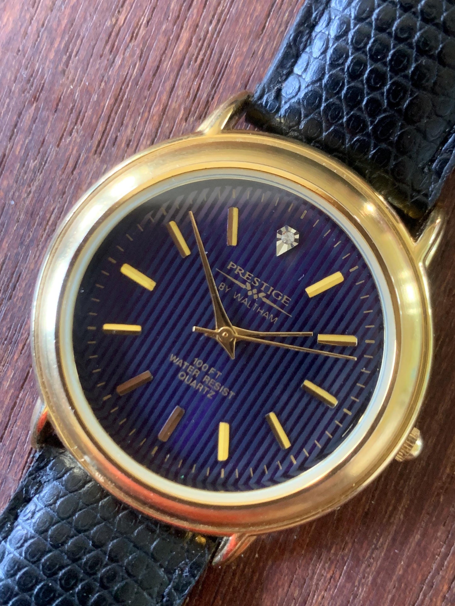 Prestige by Waltham Diamond Dial Quartz Watch.  Gold Tone with striped dial, black and deep blue. Classic Retro Style. Leather Band. Unworn.