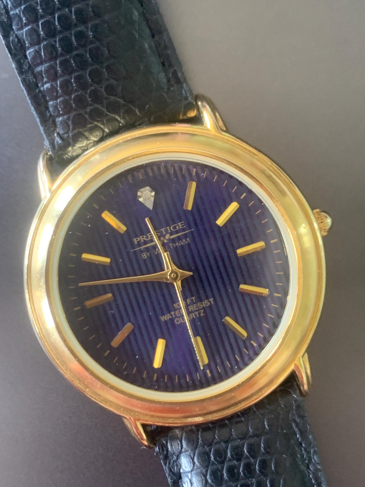 Prestige by Waltham Diamond Dial Quartz Watch.  Gold Tone with striped dial, black and deep blue. Classic Retro Style. Leather Band. Unworn.