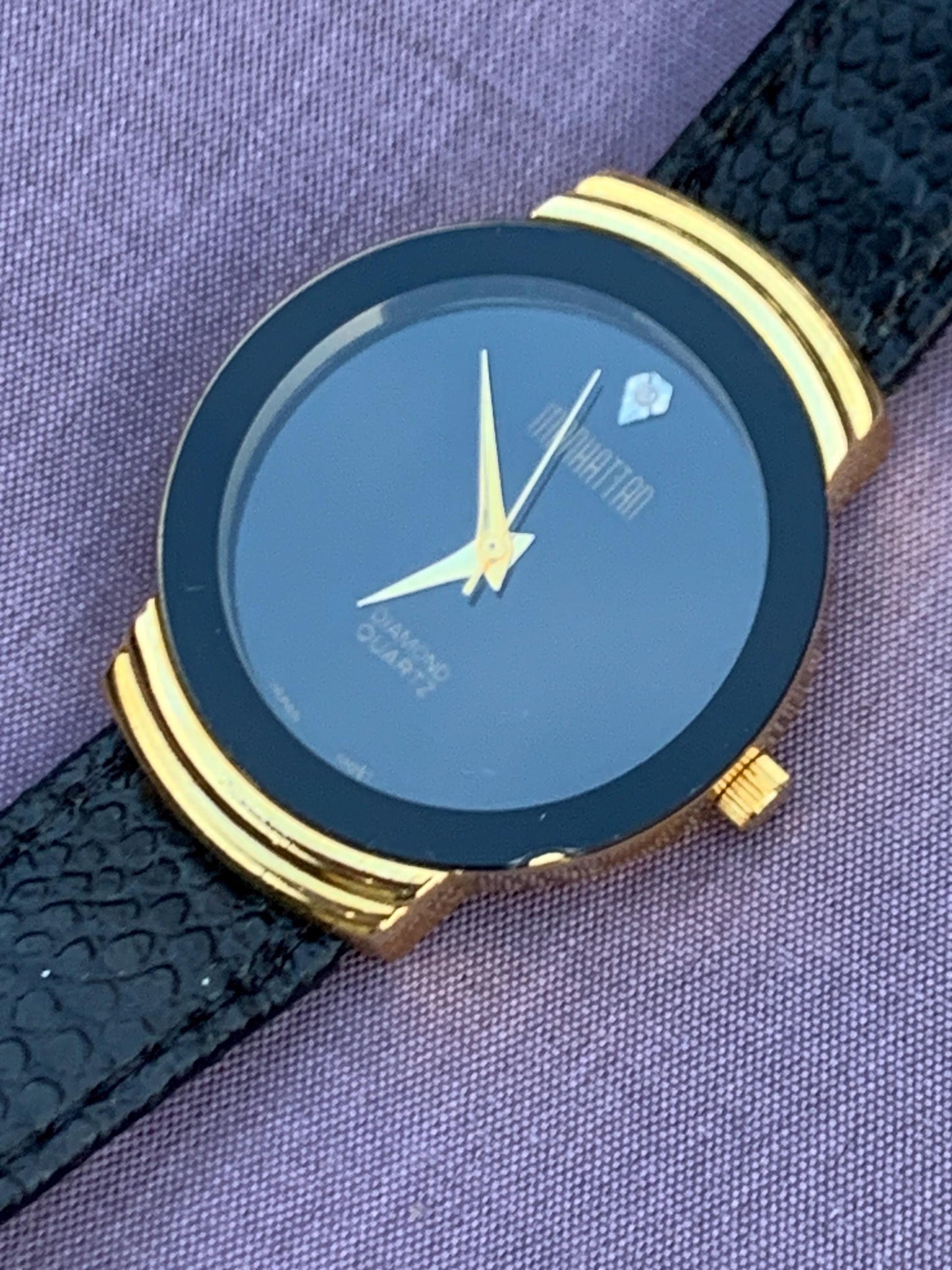 Manhattan 'Diamond' Quartz Museum watch. Fancy lugs, great gold tone. Black dial without indices. Keeps time well. 1990s. Small chip crystal