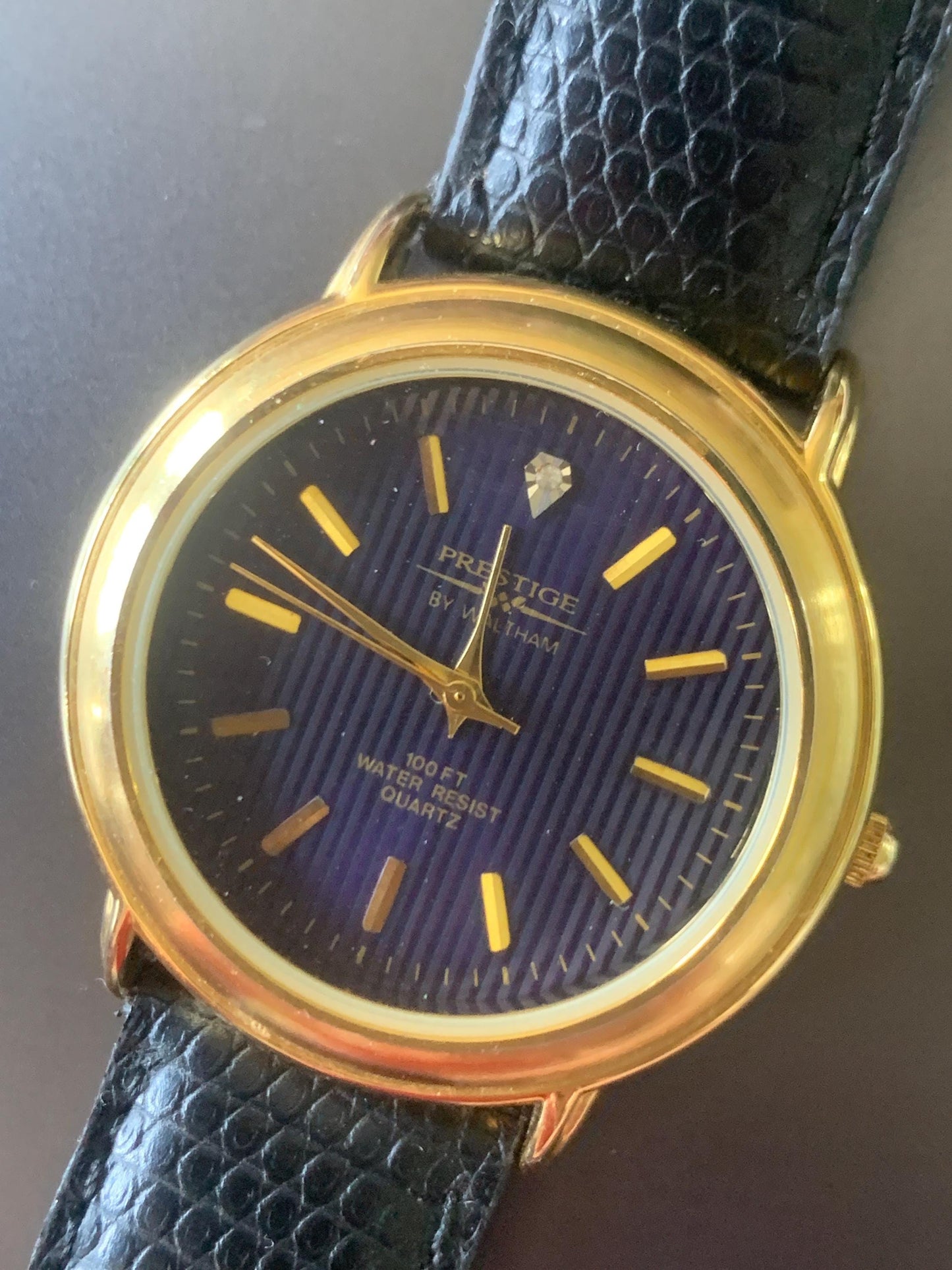 Prestige by Waltham Diamond Dial Quartz Watch.  Gold Tone with striped dial, black and deep blue. Classic Retro Style. Leather Band. Unworn.