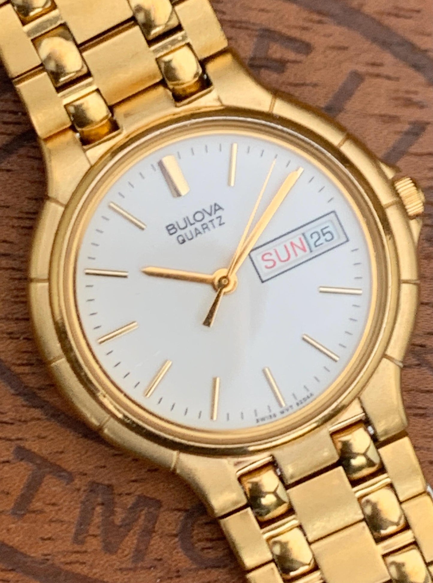 1988 Bulova Quartz Watch Gold Tone Finish, White Dial with Day/Date New battery. Original, integral metal band. Neo Vintage Quartz. Great.