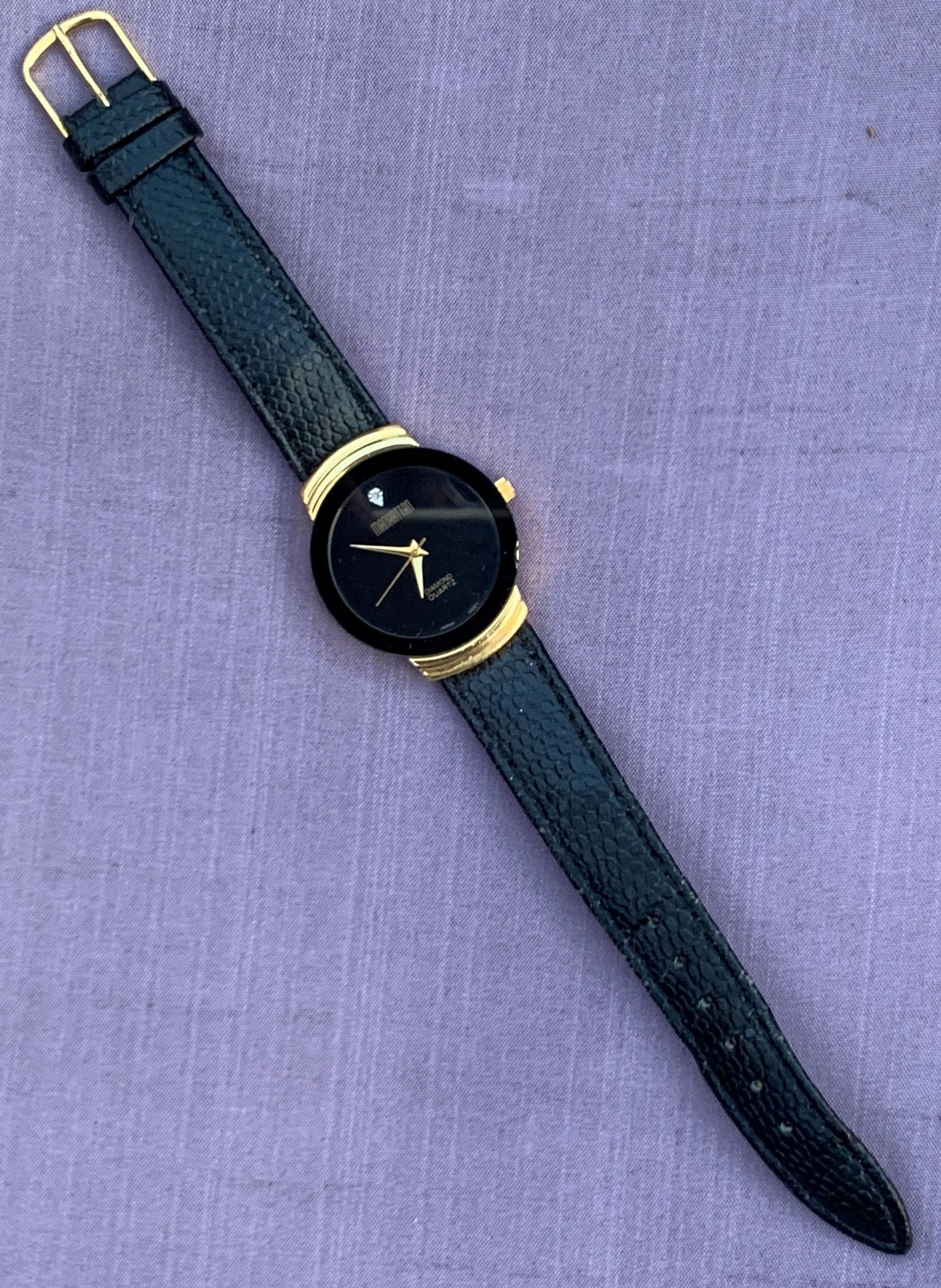 Manhattan 'Diamond' Quartz Museum watch. Fancy lugs, great gold tone. Black dial without indices. Keeps time well. 1990s. Small chip crystal