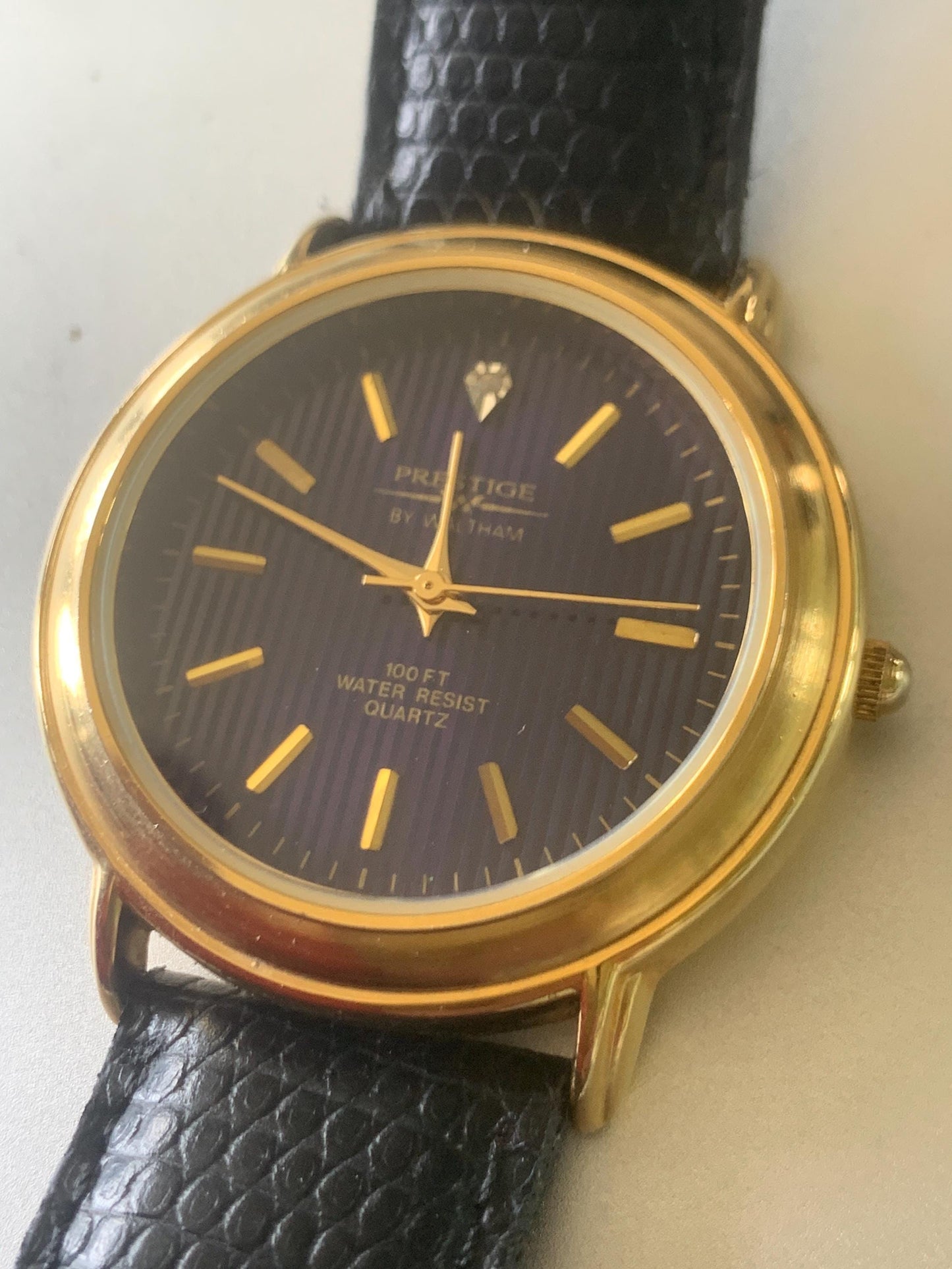 Prestige by Waltham Diamond Dial Quartz Watch.  Gold Tone with striped dial, black and deep blue. Classic Retro Style. Leather Band. Unworn.
