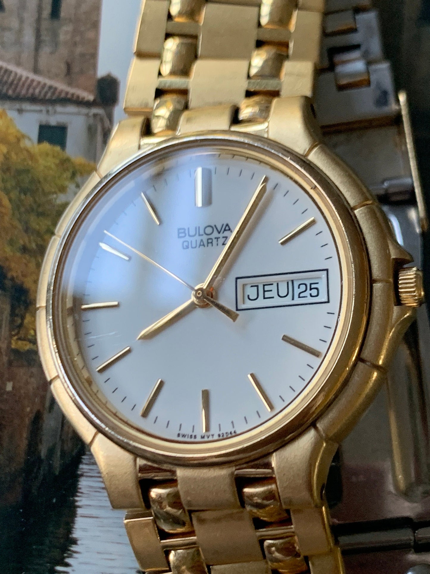 1988 Bulova Quartz Watch Gold Tone Finish, White Dial with Day/Date New battery. Original, integral metal band. Neo Vintage Quartz. Great.