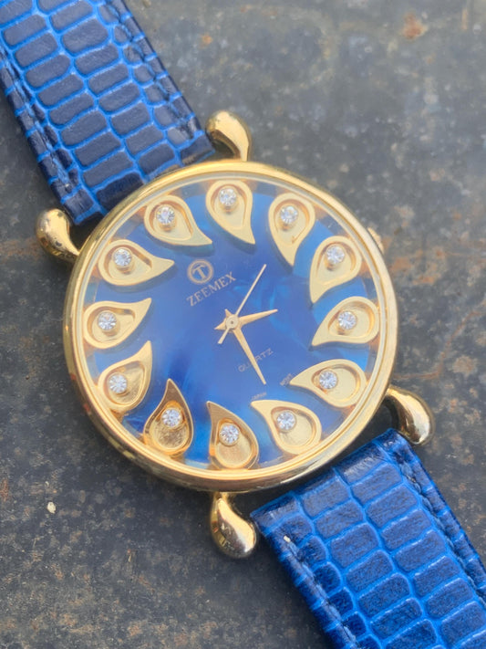 Luminescent Blue 1990s Quartz Watch - 37mm, Gold Indices with Floating Jewels on Ultra Radiant Blue Dial. New battery & NOS blue strap. Fun!
