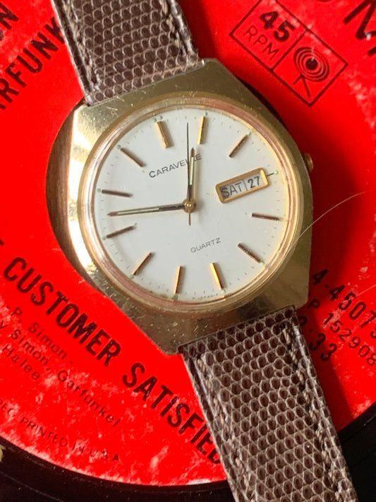 1980s Caravelle by Bolova Quartz Watch Gold Tone Finish, White Dial with Day/Date New battery. New Lizard Style Band. Overall Good Condition