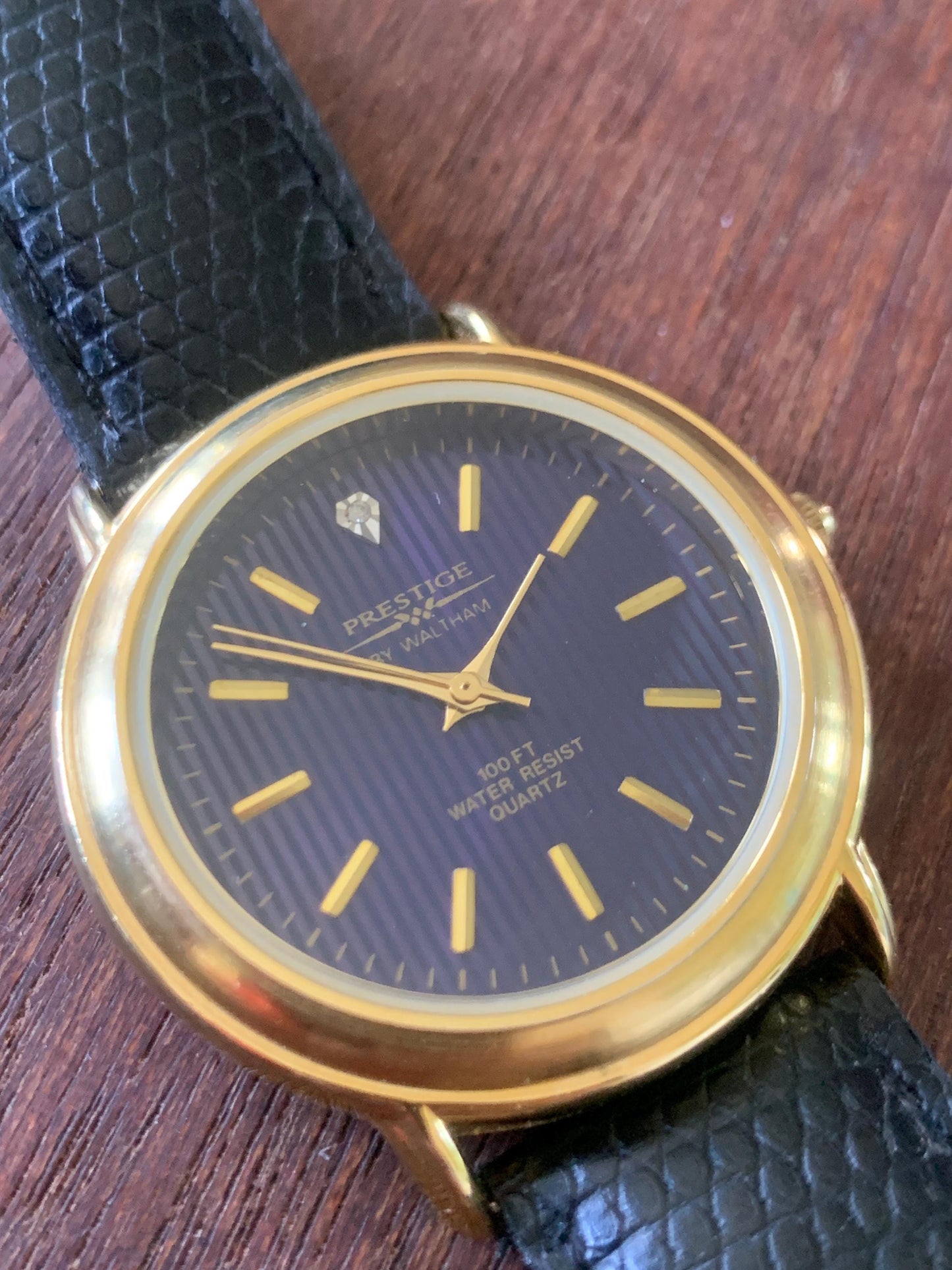 Prestige by Waltham Diamond Dial Quartz Watch.  Gold Tone with striped dial, black and deep blue. Classic Retro Style. Leather Band. Unworn.