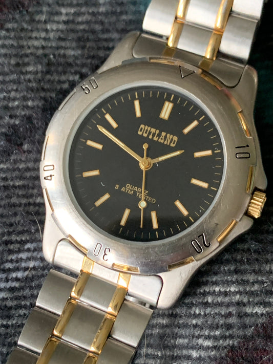 Outland Watch 1990s - Diver Style, Silver tone w/gold tone accents, Black Dial, Good Condition, Good Weight, Works Well. New Battery.