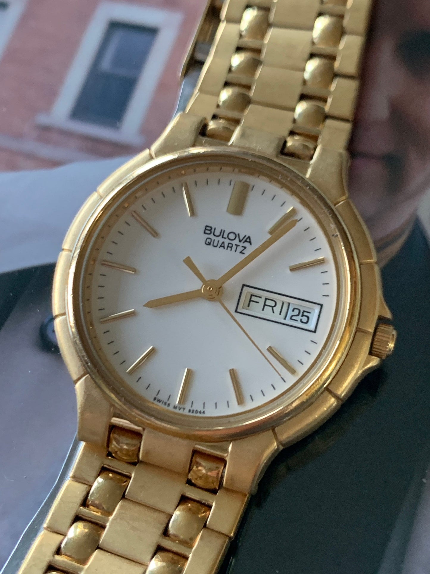1988 Bulova Quartz Watch Gold Tone Finish, White Dial with Day/Date New battery. Original, integral metal band. Neo Vintage Quartz. Great.