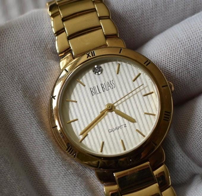 Classic Bill Blass Quartz Watch - Elegant Striped Dial with Roman Bezel, Goldtone, Excellent Condition, Integral Bracelet, Slim, All links.